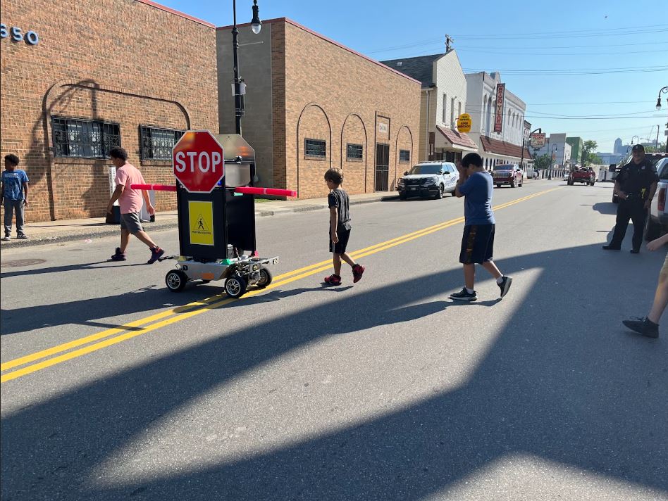 Robot Helping Pedestrians Cross Intersections Safely